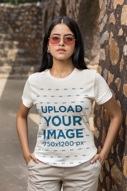 Basic T-Shirt Mockup Featuring a Serious Woman With Sunglasses With Her Hands in Her Pockets