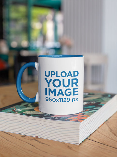 Mockup of a Two-Toned 11 oz Coffee Mug Mockup on a Table