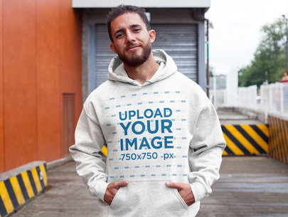 Mockup of a Man Wearing a Heather Hoodie at a Parking Lot