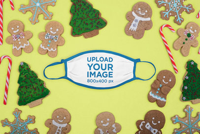 Mockup of a Flat Laid Face Mask Surrounded by Christmas Gingerbread Cookies