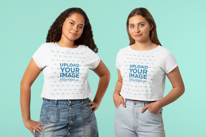 Mockup of Two Young Friends with Crop Top Tees  Posing at a Studio 