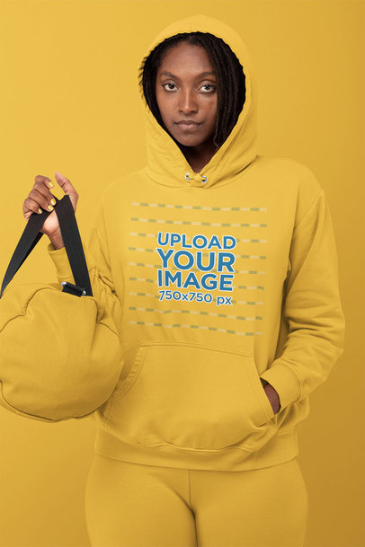 Hoodie Mockup Featuring a Woman in a Monochromatic Outfit at a Studio 
