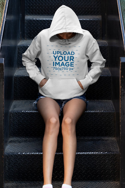 Hoodie Mockup of a Young Woman Sitting on Some Steps