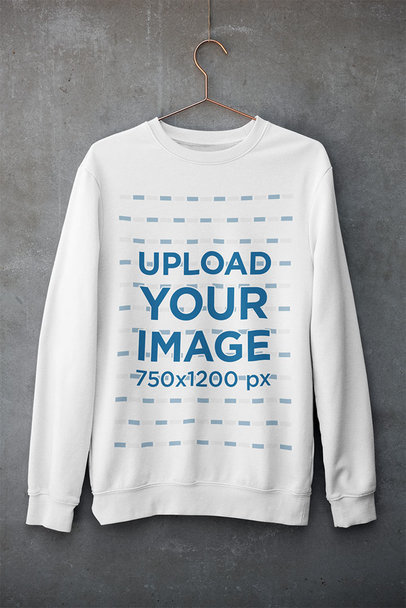Mockup of a Customizable Crewneck Sweatshirt Hanging Against a Concrete Wall 