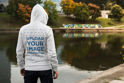 Back-View Mockup of a Man Wearing a Hoodie by a Lake