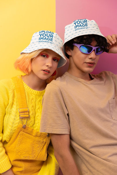 Sublimated Bucket Hat Mockup of a Man and a Woman in a New Pop Wave-Inspired Background