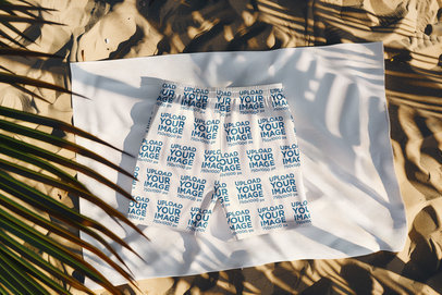 AI-Created Mockup Featuring Swim Trunks Flat Laid on the Sand at the Beach