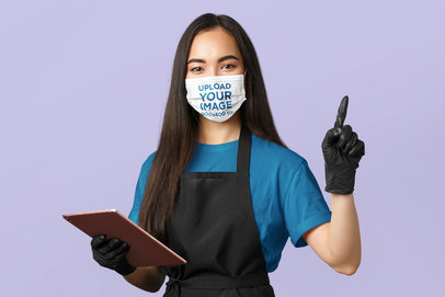 Face Mask Mockup Featuring a Woman With Latex Gloves Posing Against a Plain Background 