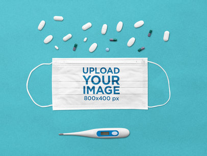 Face Mask Mockup Featuring a Thermometer and Some Pills
