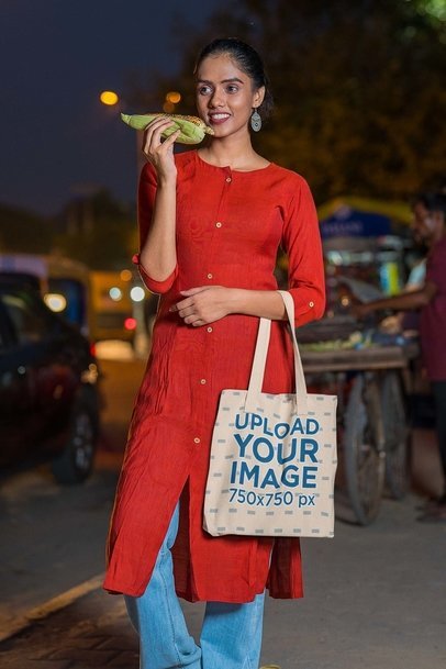 Tote Bag Mockup of a Woman Eating Street Food at Night