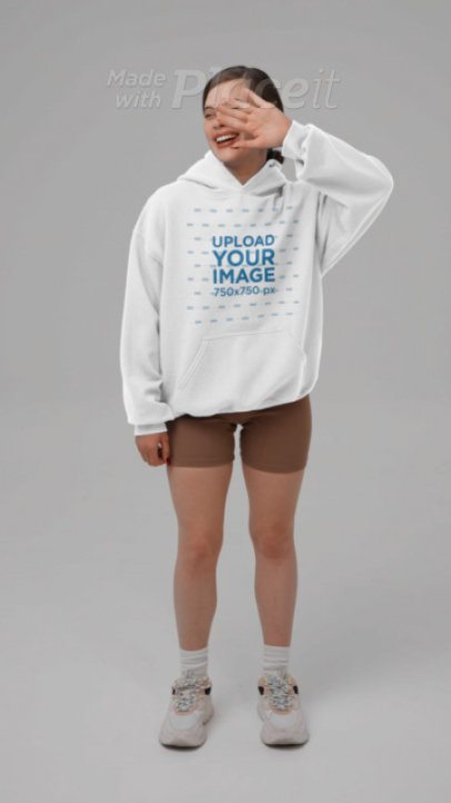 Gildan Pullover Hoodie Video Featuring a Cheerful Woman Covering Her Face
