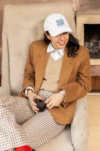 Dad Hat Mockup of a Woman Sitting on an Armchair with a Grandpacore-Style Look