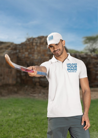 Polo Shirt and Hat Mockup of a Smiling Man Holding a Cricket Bat