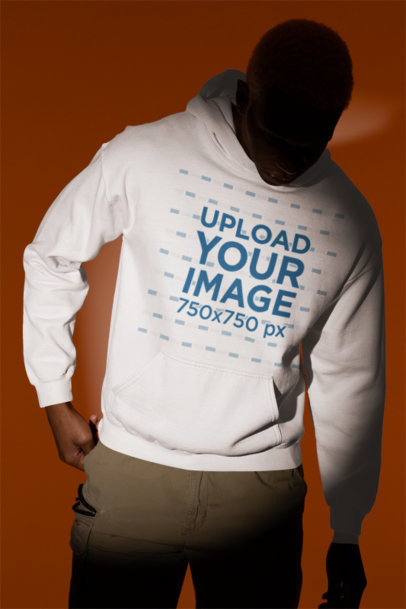 Spotlight-Themed Mockup of a Man Wearing a Gildan Pullover Hoodie in a Studio