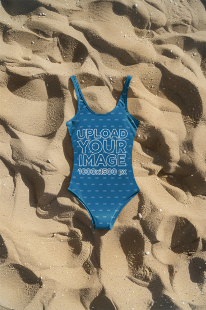 Sublimated Swimwear Mockup of a Swimsuit Laying Flat Over Beach Sand