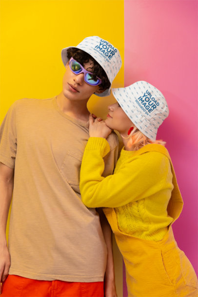Bucket Hat Mockup of a Smiling Woman Posing With a Man in a New Pop Wave-Inspired Set