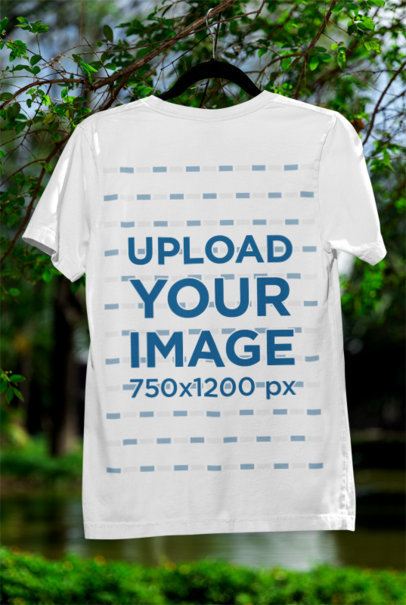 Mockup of a Bella Canvas T-Shirt Placed on a Hanger in a Nature Setting