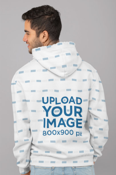 Back View Mockup of a Man Wearing a Sublimated Hoodie in a Studio