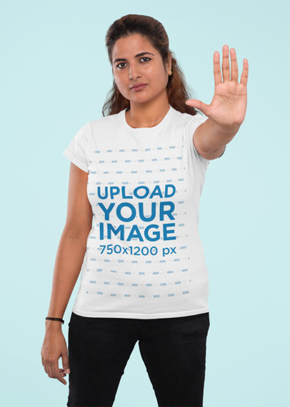 T-Shirt Mockup Featuring a Woman Doing a Halt Sign with Her Hand
