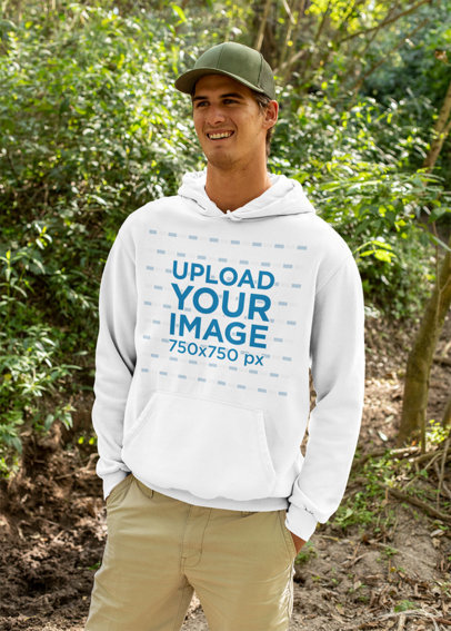 Mockup of a Happy Man Wearing a Hoodie in the Woods