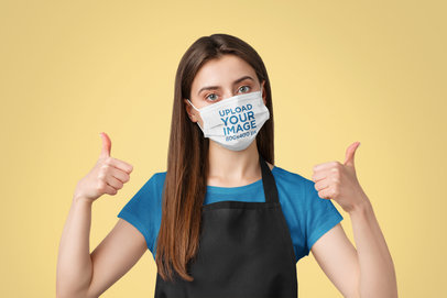 Face Mask Mockup Featuring a Cheery Waitress in a Studio