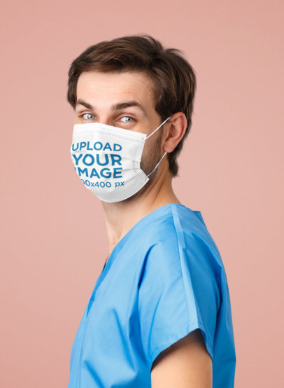 Face Mask Mockup of a Male Health Professional Standing in a Studio