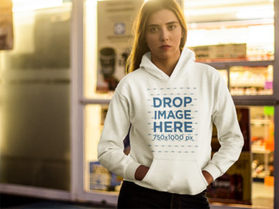 Young White Woman Wearing a Pullover Hoodie While Outside of the Supermarket Mockup
