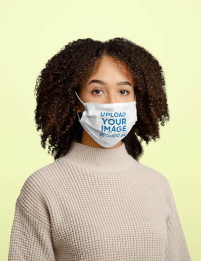 Face Mask Mockup of a Curly-Haired Woman Standing in a Studio